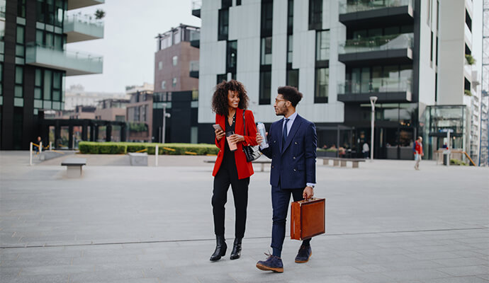 couple-in-office-attire-walking-business-district-outdoors-bdo