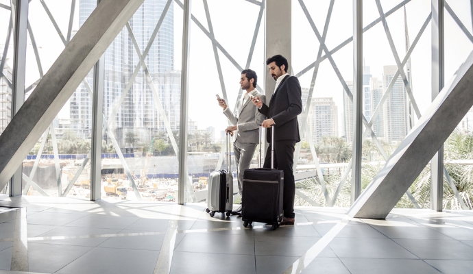 two-men-with-suitcases-reading-news-bdo