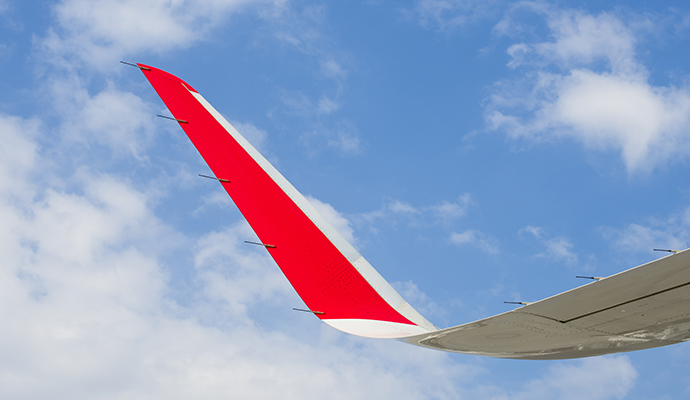 red-and-white-airplane-wing-on-sky-background