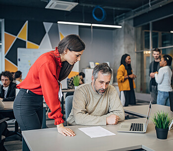 man-and-woman-discussing-over-document