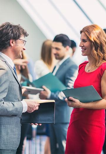 Networking in an office setting, holding-folders.